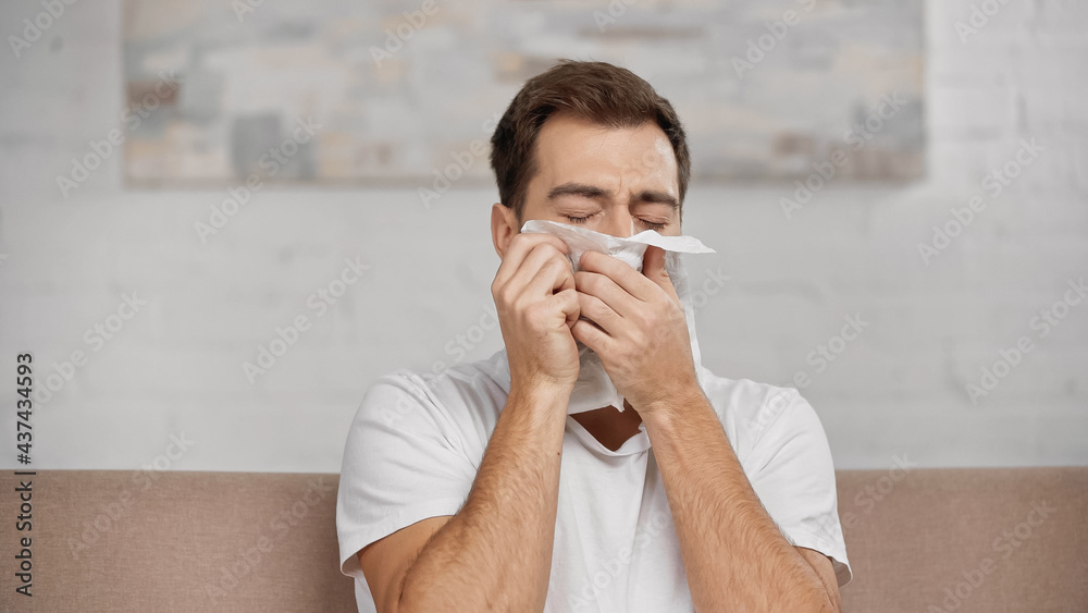allergic man sneezing in napkin at home allergic man sneezing in napkin at home