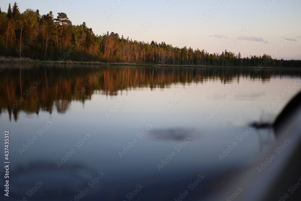 Rowing Boat Over Lake With Forest In The Background in the Fall