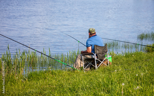 A man with a fishing rod is fishing on the shore