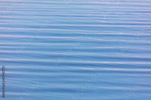 The smooth surface of the water in the lake as an abstract background.