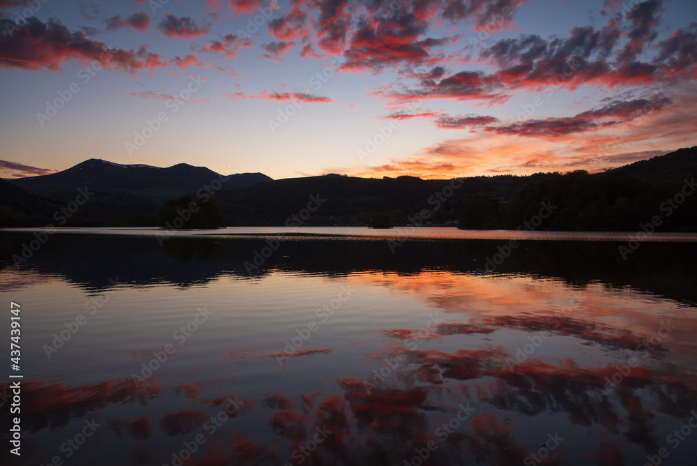 Stunning sunset at Chambon lake in Auvergne Volcanic Regional Nature Park, France.