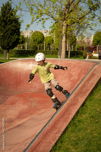 A boy roller-skates in a rollerdrom photo