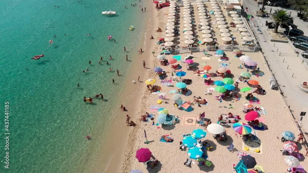 Aerial overhead view of lined beach umbrellas on a tropical beach. Slow motion Aerial overhead view of lined beach umbrellas on a tropical beach. Slow motion