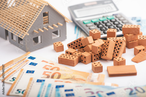Fototapeta Naklejka Na Ścianę i Meble -  Home Purchase Savings Concept. Euro Money Stack With Red House