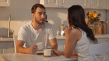bearded man holding cup and talking with blurred girlfriend
