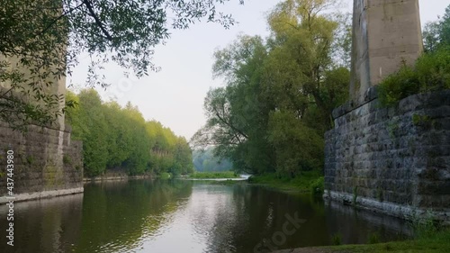 River flowing under a tall bridge in Elora Ontario photo