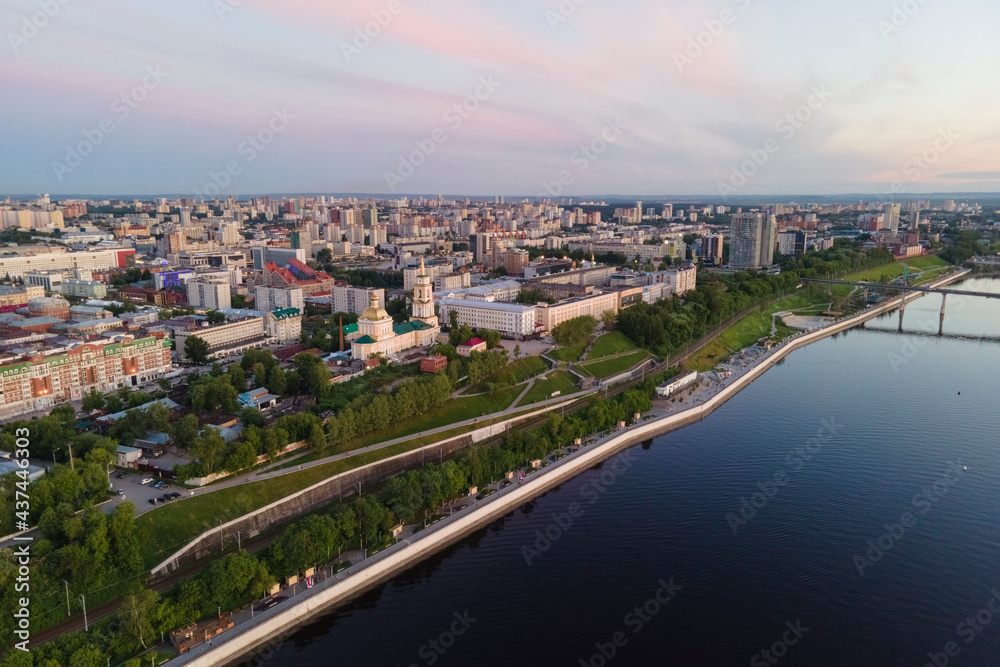 Aerial view of Perm and historical building of art gallery, Kama river with bridge in sunny summer day with green trees in the sunset