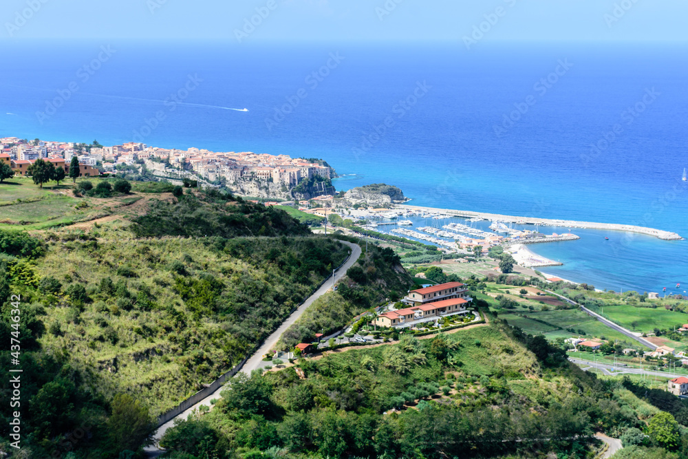 An areal view of picturesque holiday town of Tropea on a clear blue-sky day during late summer 
