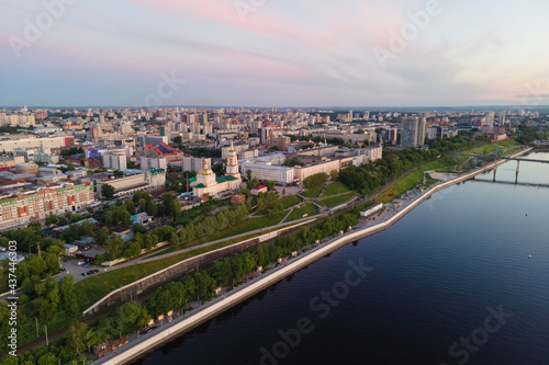 Aerial view of Perm and historical building of art gallery  Kama river with bridge in sunny summer day with green trees in the sunset