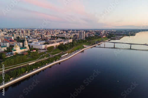 Aerial view of Perm and historical building of art gallery, Kama river with bridge in sunny summer day with green trees in the sunset