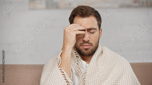 bearded man suffering from headache at home © LIGHTFIELD STUDIOS