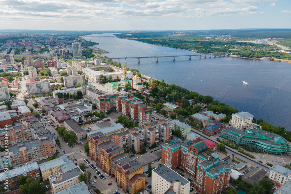 Naklejka premium Aerial view of Perm and historical building of art gallery, Kama river with bridge in sunny summer day with green trees