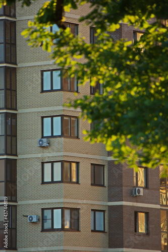 Reflections of a summer sunset in the windows of houses.