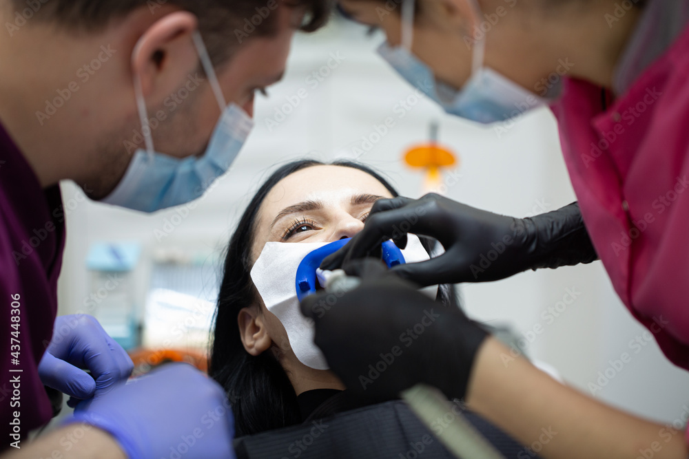 A woman at a dentist's teeth whitening appointment A woman at a dentist's teeth whitening appointment
