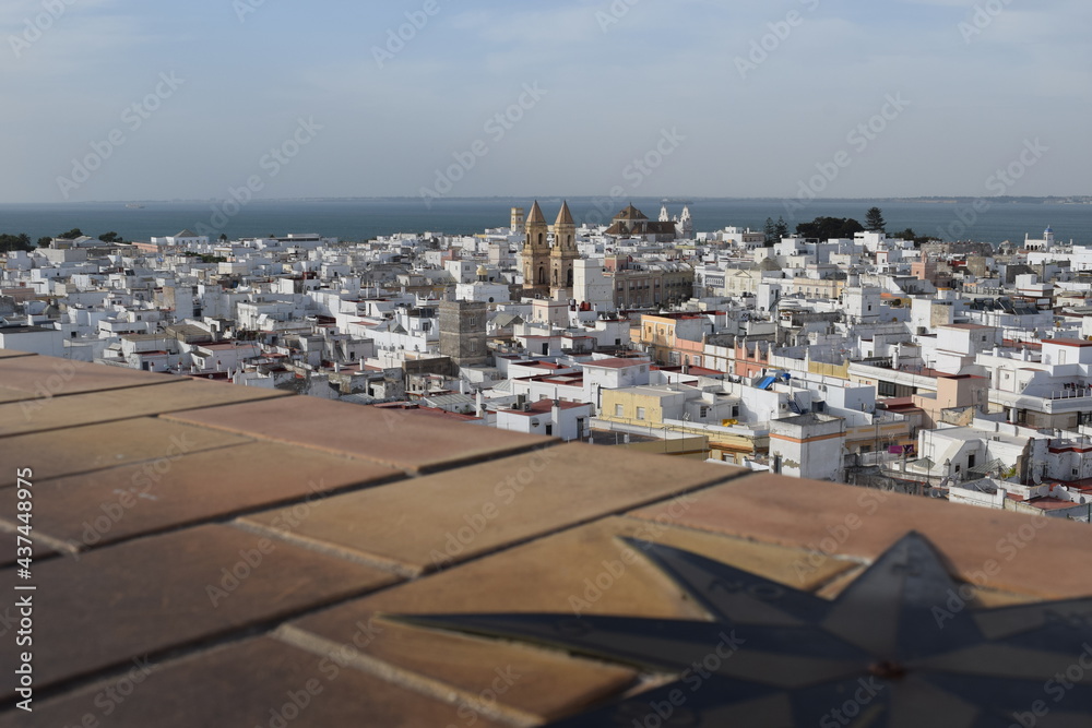 Epectacular top-view to the rooftops of the historical old city from cadiz andalusia spain europe, a compass is showing the direction, interesting buildings and architecture from medieval at the coast