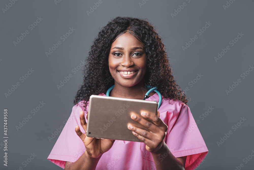 An African doctor consults a patient, makes a video call from a webcam on the tablet screen. Telemedicine videoconference remote computer application virtual meeting. An African doctor consults a patient, makes a video call from a webcam on the tablet screen. Telemedicine videoconference remote computer application virtual meeting.