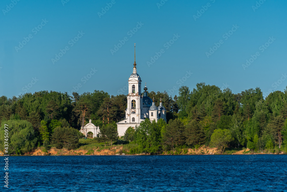 Old Orthodox Temple of Ascension by the river in the forest.
