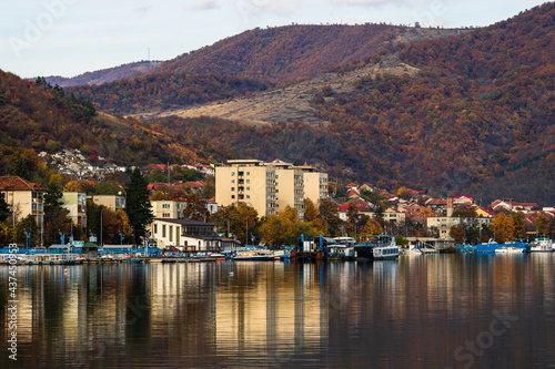 View of Danube river and Orsova city vegetation and buildings, waterfront view. Orsova, Romania, 2021 photo