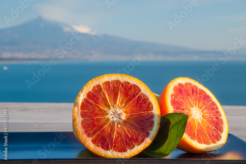 Obraz na płótnie Citrus fruits from Italy: tarocco oranges with blue sea and Mount Etna in the background w salonie