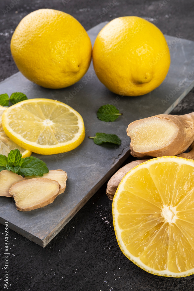 Sicilian lemon, ginger and mint on a slate stone Sicilian lemon, ginger and mint on a slate stone