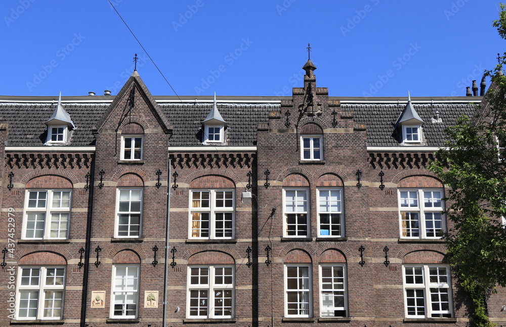 Amsterdam Jordaan Traditional Brown Brick Building Facade with Blue Sky