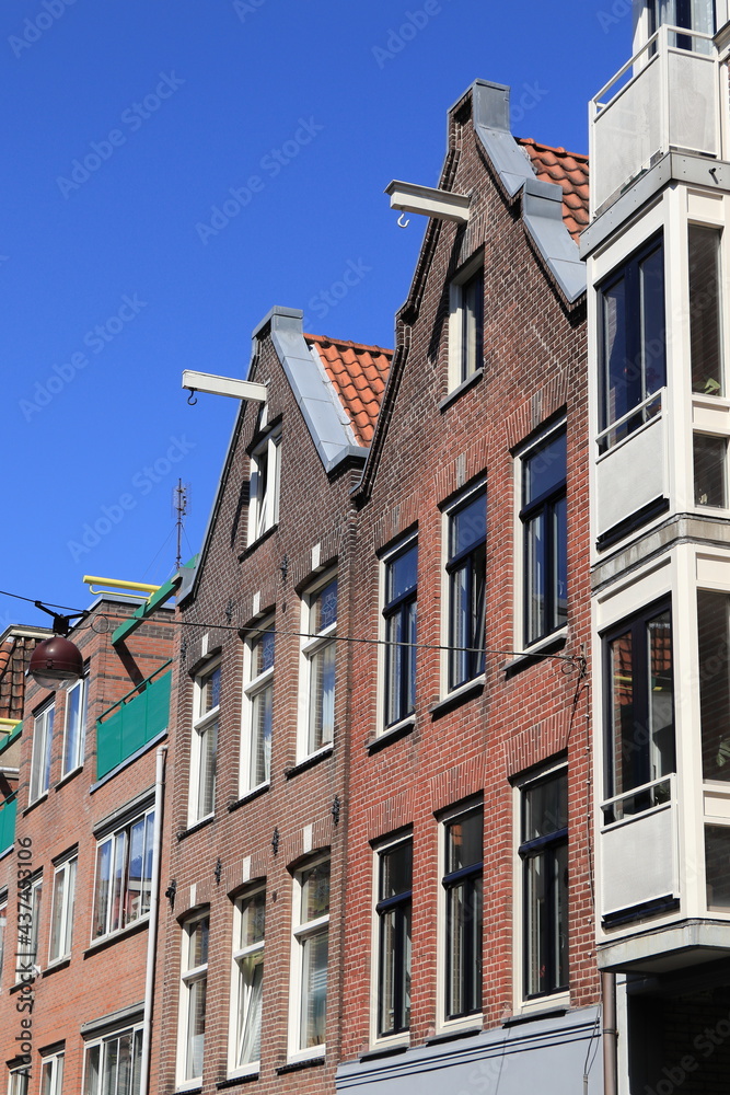 Amsterdam Jordaan Traditional House Facades with Spout Gables Against a Blue Sky