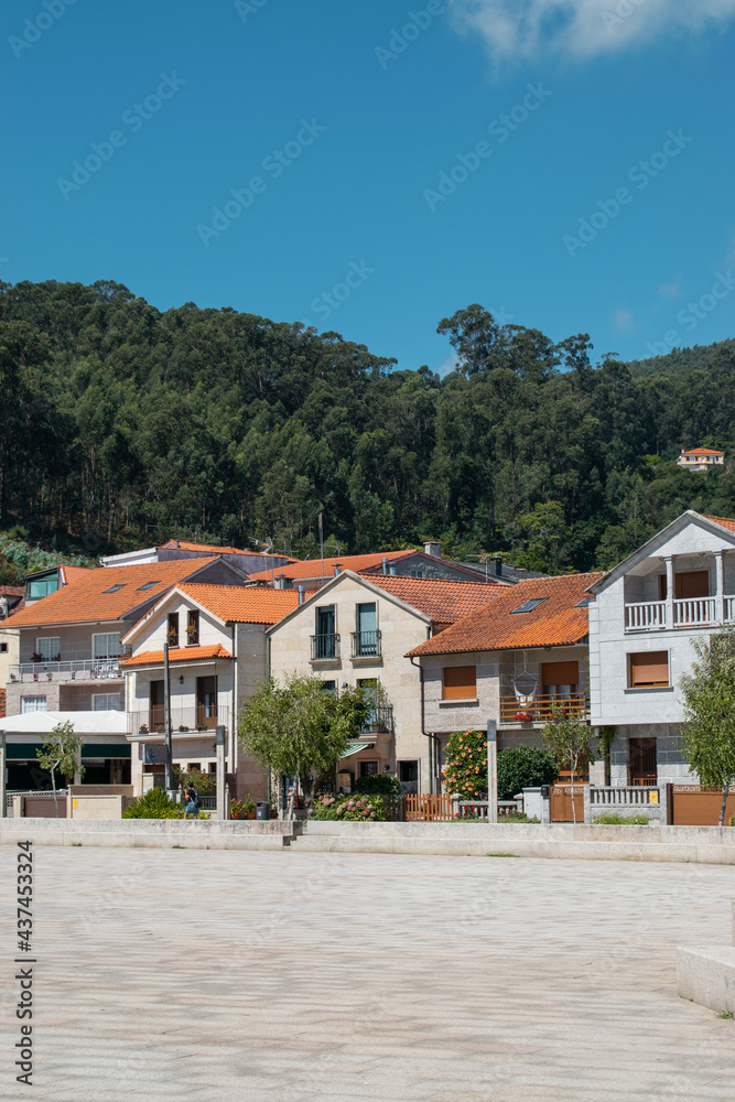 Naklejka premium set of beautiful houses on the main square of the town of Combarro in Galicia