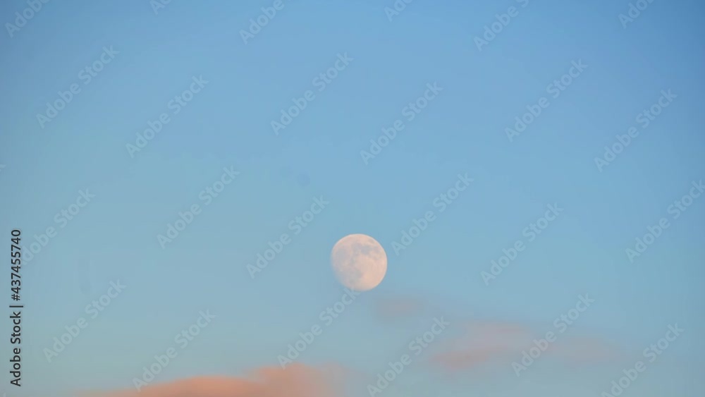 Moon transition across the sky with blue clear sky to cloud cover. Changing weather conditions watching moon Moon transition across the sky with blue clear sky to cloud cover. Changing weather conditions watching moon