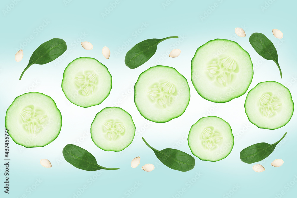 Flying fresh sliced cucumber with seeds on green background. Cucumber or vegetables in the air Flying fresh sliced cucumber with seeds on green background. Cucumber or vegetables in the air