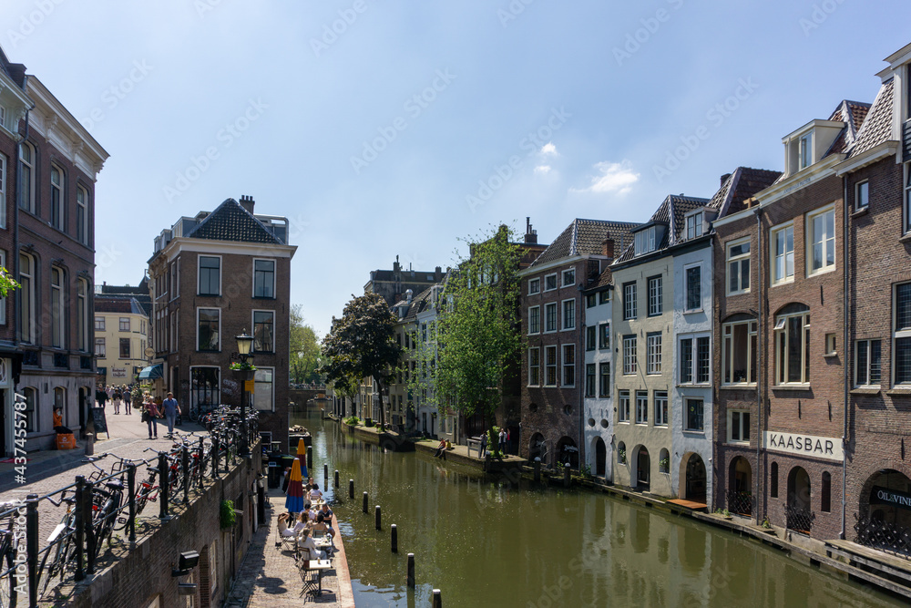 View of a typical Dutch canal with bicycles and houses