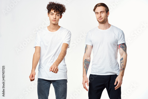 two funny friends in white t-shirts laughing positive emotions