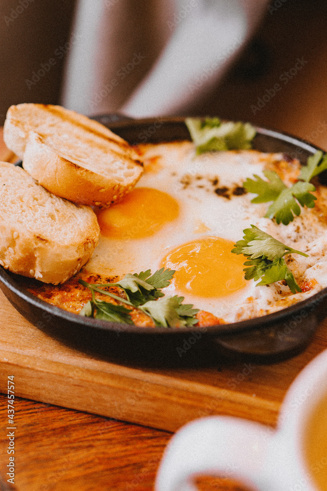 Breakfast with eggs and tomato, in a frying pan Breakfast with eggs and tomato, in a frying pan