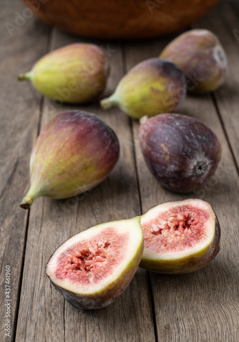 Figs with cut fruit over wooden table. Short depth of field