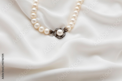 A pearl necklace against white background