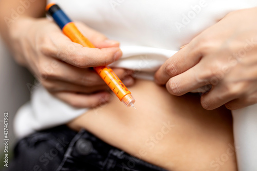 woman doing injection with insulin pen