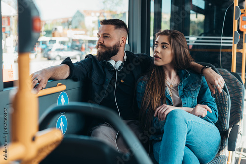 Young beautiful couple in love sitting in a bus