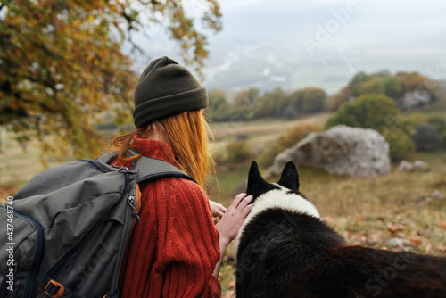 woman tourist playing with dog outdoors fun travel friendship
