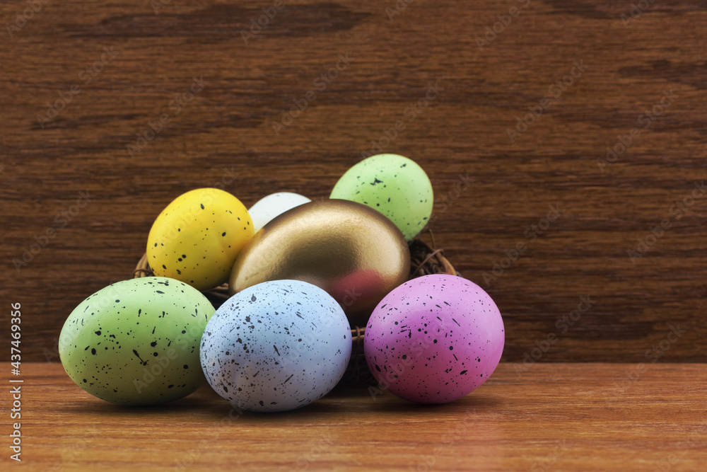 Gold egg in nest surrounded by multiple, colorful eggs symbolize success of strategic diversification in financial investing Gold egg in nest surrounded by multiple, colorful eggs symbolize success of strategic diversification in financial investing