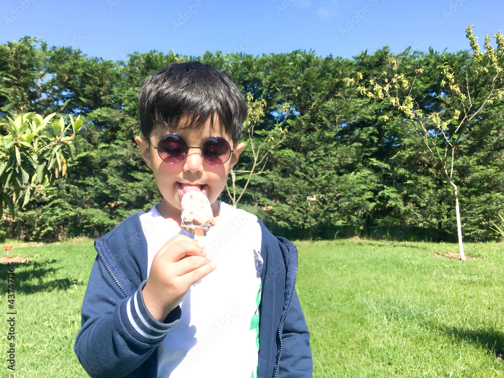 Fototapeta premium Small child eating ice cream