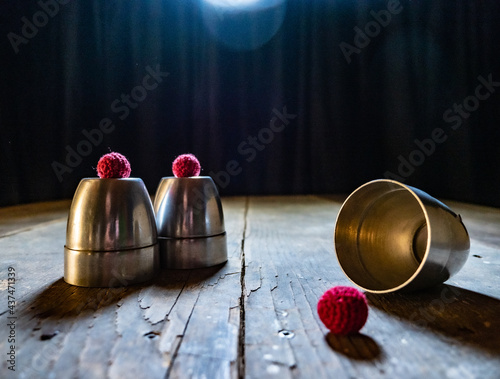 Magician show cups and balls close-up magic trick photo