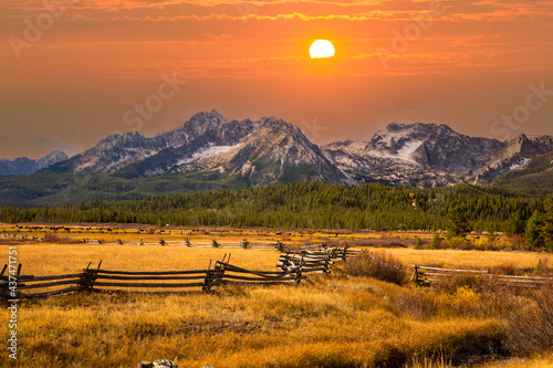 a split rail fence, pasture and meadow, and the Sawtooth Mountains near Stanley, Idaho.