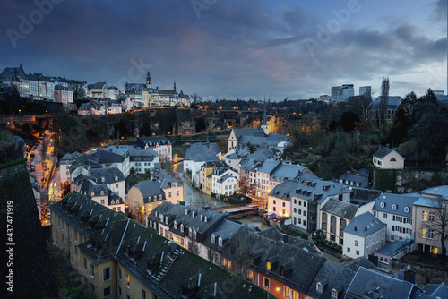 Luxembourg city skyline at night - Aerial view of The Grund with St Michaels Church on background - Luxembourg City, Luxembourg