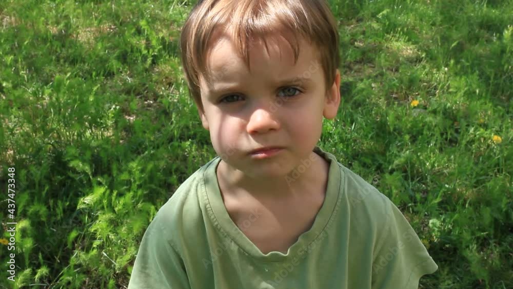 little boy eats green apple outside little boy eats green apple outside