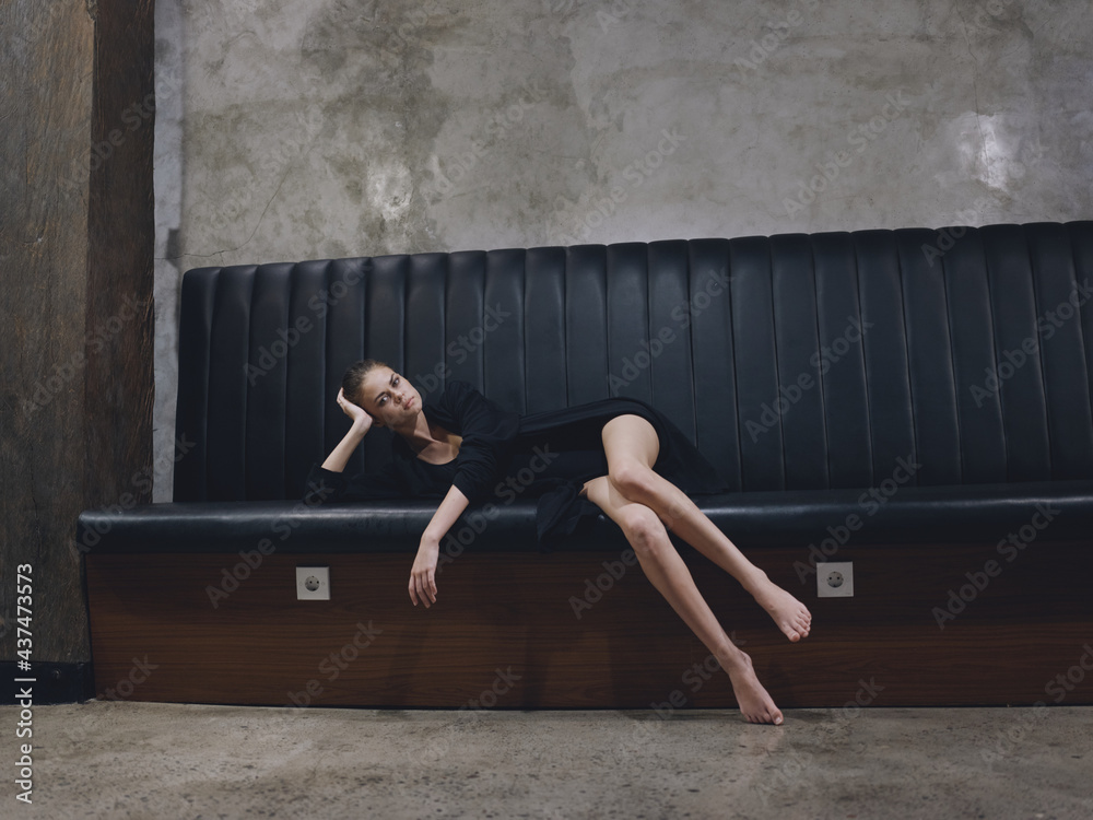 A woman is waiting for a flight on an airplane lying on a bench in a dark room A woman is waiting for a flight on an airplane lying on a bench in a dark room