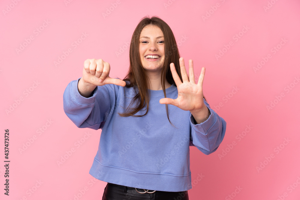 Teenager caucasian girl isolated on pink background counting six with fingers Teenager caucasian girl isolated on pink background counting six with fingers