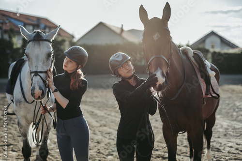 Beautiful young women enjoying with their horses..
