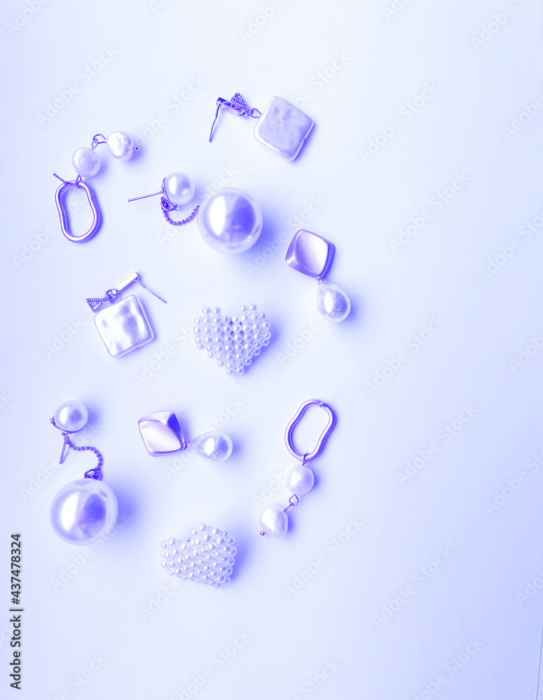 Modern accessories. Set of beautiful precious jewelry made of color gold, silver, and pearls. Fashion photos Modern accessories. Set of beautiful precious jewelry made of color gold, silver, and pearls. Fashion photos