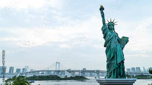 Statue of Liberty and rainbow bridge view at the afternoon time in Odaiba area  Tokyo  Japan