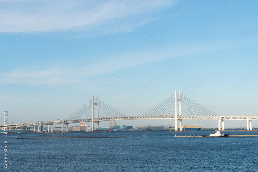 Exterior architecture and view of Yokohama bridge and Yokohama bay on the blue sky day. Yokohama is one of tourist destination place in visiting Japan and landmark for business and industrial in Kanto