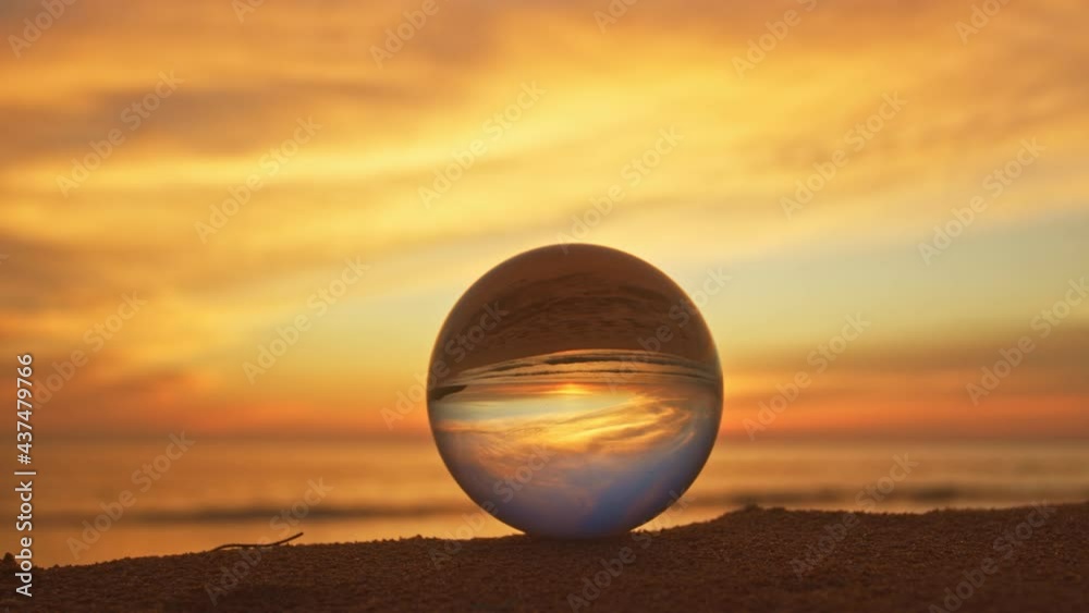 The natural view of the sea and sky in beautiful sunset are unconventional and beautiful inside crystal ball. .A image for a unique and creative travel idea. The natural view of the sea and sky in beautiful sunset are unconventional and beautiful inside crystal ball. .A image for a unique and creative travel idea.